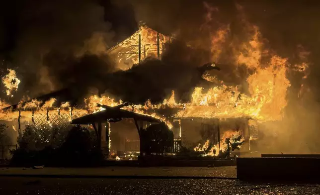 FILE - A building burns after a Russian strike in Mykolaiv, Ukraine, on Oct. 15, 2024. (AP Photo/Marko Ivkov, File)