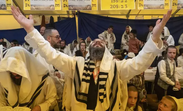 Orthodox Jews pray at the tomb of Rabbi Nachman, the great grandson of the founder of Hasidic movement, in the town of Uman, 200 kilometres (125 miles) south of Ukraine's capital Kyiv, Ukraine, Thursday, Oct. 3, 2024. (AP Photo/Efrem Lukatsky)