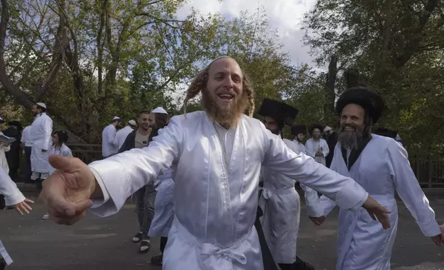 Orthodox Jews dance at the tomb of Rabbi Nachman, the great grandson of the founder of Hasidic movement, in the town of Uman, 200 kilometres (125 miles) south of Ukraine's capital Kyiv, Ukraine, Thursday, Oct. 3, 2024. (AP Photo/Efrem Lukatsky)