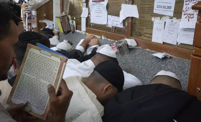 Orthodox Jews pray at the gravestone of Rabbi Nachman, the great grandson of the founder of Hasidic movement, to mark the Jewish new year in the town of Uman, 200 kilometers (125 miles) south of Ukraine's capital Kyiv, Ukraine, Thursday, Oct. 3, 2024. (AP Photo/Efrem Lukatsky)