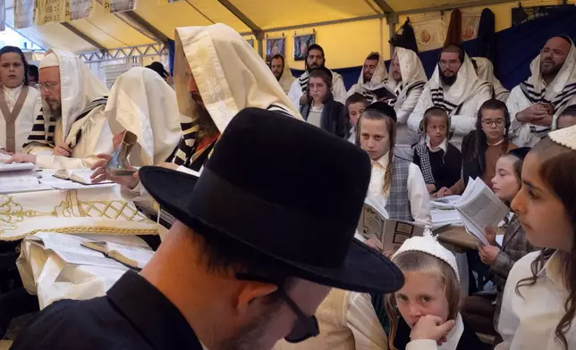 Orthodox Jews pray at the gravestone of Rabbi Nachman, the great grandson of the founder of Hasidic movement, to mark the Jewish new year in the town of Uman, 200 kilometers (125 miles) south of Ukraine's capital Kyiv, Ukraine, Thursday, Oct. 3, 2024. (AP Photo/Efrem Lukatsky)