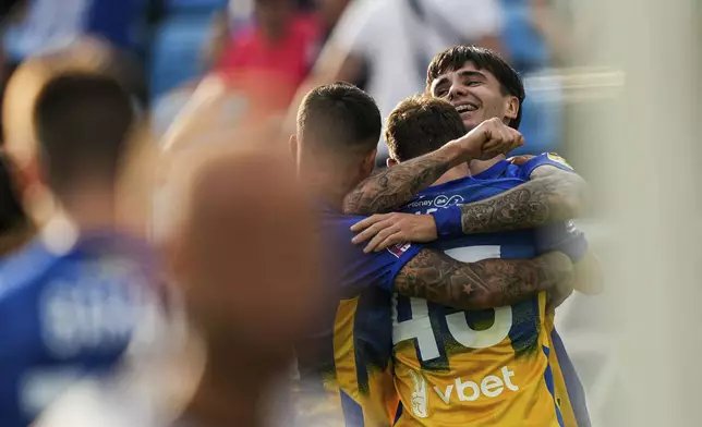 Mykola Shparenko of Dynamo Kyiv celebrates his goal with teammates during a soccer match with Zorya Luhansk in Kyiv, Ukraine, Saturday Sept. 14, 2024. (AP Photo/Evgeniy Maloletka)