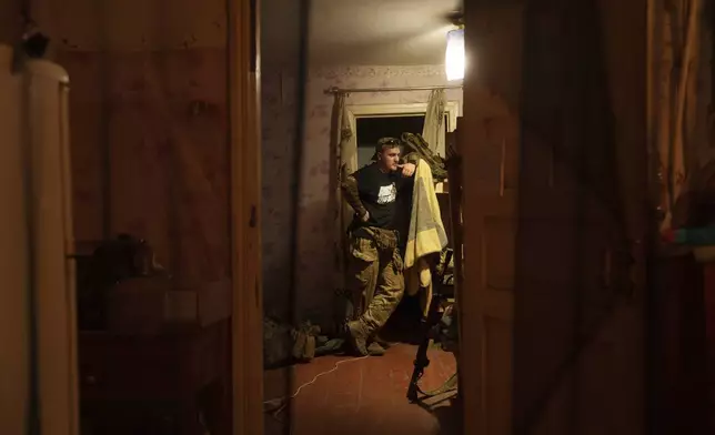 Ukrainian serviceman known by the call sign "Tankist" of the 3rd assault brigade stands in a room of a house not far from the frontline in Kharkiv region, Ukraine, Sunday Sept. 22, 2024. (AP Photo/Evgeniy Maloletka)