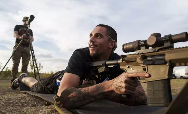 Ukrainian serviceman known by the call sign "Shtahet" of the 3rd assault brigade trains to fire by his rifle at the polygon in Kharkiv region, Ukraine, Thursday Sept. 26, 2024. (AP Photo/Evgeniy Maloletka)