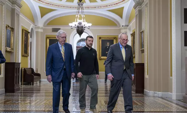 FILE - Ukrainian President Volodymyr Zelenskyy, center, walks with Senate Minority Leader Mitch McConnell, R-Ky., left, and Senate Majority Leader Chuck Schumer, D-N.Y., as he arrives for a briefing with lawmakers about the war effort against Russia, at the Capitol in Washington, Thursday, Sept. 26, 2024. (AP Photo/J. Scott Applewhite, File)