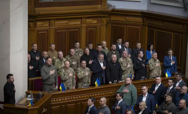 In this photo provided by the Press Service Of The President Of Ukraine on Oct. 16, 2024, Ukraine's President Volodymyr Zelenskyy listens to the national anthem before his speech at Verkhovna Rada in Kyiv, Ukraine. (Press Service Of The President Of Ukraine via AP)