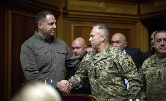 In this photo provided by the Press Service Of The President Of Ukraine on Oct. 16, 2024, Head of Ukrainian Presidential Office Andriy Yermak, left, shakes hand with Commander-in-Chief of the Armed Forces of Ukraine General Oleksandr Syrskyi at Verkhovna Rada in Kyiv, Ukraine. (Press Service Of The President Of Ukraine via AP)