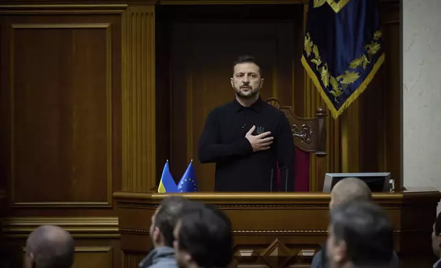 In this photo provided by the Press Service Of The President Of Ukraine on Oct. 16, 2024, Ukraine's President Volodymyr Zelenskyy listens to the national anthem before his speech at Verkhovna Rada in Kyiv, Ukraine. (Press Service Of The President Of Ukraine via AP)