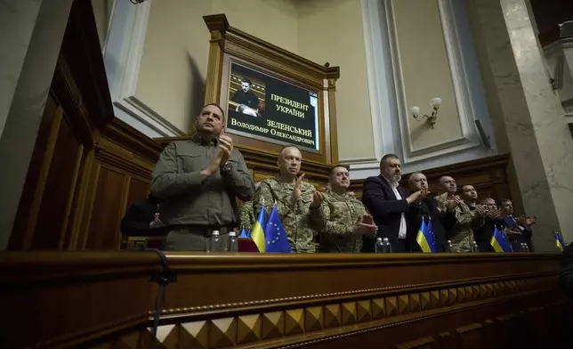 In this photo provided by the Press Service Of The President Of Ukraine on Oct. 16, 2024, Head of Ukrainian Presidential Office Andriy Yermak,left, Commander-in-Chief of the Armed Forces of Ukraine General Oleksandr Syrskyi, Lieutenant Generel Bargilevich Anatoly Chief of the General Staff of the Armed Forces of Ukraine, Oleksandr Lytvynenko Head of Foreign Intelligence Service of Ukraine, Maj. Gen. Vasyl Maliuk Chief of Ukraine's Security Service, Maj. Gen. Kyrylo Budanov, Ukraine's military intelligence chief, listen a speech of Ukraine's President Volodymyr Zelenskyy at Verkhovna Rada in Kyiv, Ukraine. (Press Service Of The President Of Ukraine via AP)