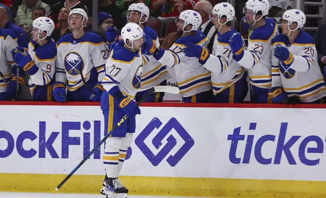 Buffalo Sabres right wing JJ Peterka celebrates with teammates on the bench after scoring a goal during the second period of an NHL hockey game against the Chicago Blackhawks, Saturday, Oct. 19, 2024, in Chicago. (AP Photo/Melissa Tamez)