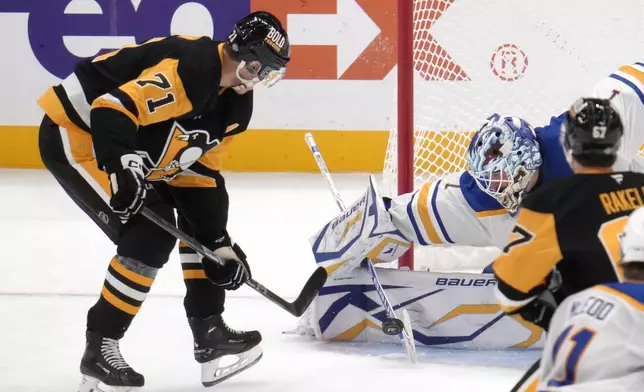 Buffalo Sabres goaltender Ukko-Pekka Luukkonen (1) stops a shot attempt by Pittsburgh Penguins' Evgeni Malkin (71) during the third period of an NHL hockey game in Pittsburgh, Wednesday, Oct. 16, 2024. (AP Photo/Gene Puskar)