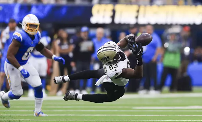 New Orleans Saints tight end Juwan Johnson (83) can't pull in a pass in the second half of an NFL football game against the Los Angeles Chargers in Inglewood, Calif., Sunday, Oct. 27, 2024. (AP Photo/Ryan Sun)