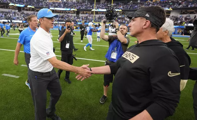 Los Angeles Chargers head coach Jim Harbaugh, left, greets New Orleans Saints head coach Dennis Allen after an NFL football game in Inglewood, Calif., Sunday, Oct. 27, 2024. The Chargers won 26-8. (AP Photo/Mark J. Terrill)