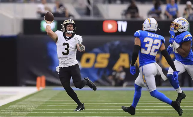 New Orleans Saints quarterback Jake Haener (3) passes in the second half of an NFL football game against the Los Angeles Chargers in Inglewood, Calif., Sunday, Oct. 27, 2024. (AP Photo/Ryan Sun)