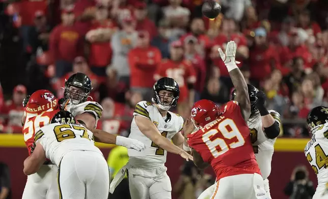 New Orleans Saints quarterback Derek Carr (4) throws over Kansas City Chiefs nose tackle Mike Pennel (69) during the first half of an NFL football game Monday, Oct. 7, 2024, in Kansas City, Mo. (AP Photo/Charlie Riedel)