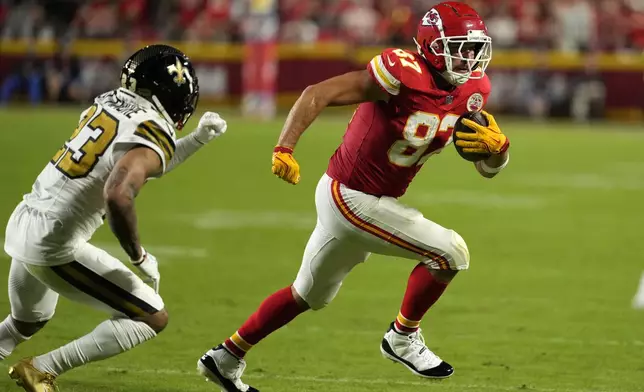 Kansas City Chiefs tight end Travis Kelce (87) runs pas New Orleans Saints cornerback Marshon Lattimore (23) during the first half of an NFL football game Monday, Oct. 7, 2024, in Kansas City, Mo. (AP Photo/Charlie Riedel)