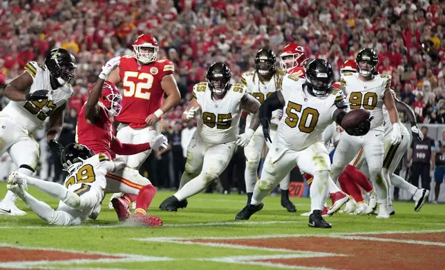 New Orleans Saints defensive tackle Khalen Saunders (50) intercepts a pass in the end zone during the second half of an NFL football game against the Kansas City Chiefs Monday, Oct. 7, 2024, in Kansas City, Mo. (AP Photo/Ed Zurga)