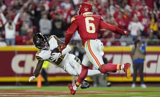 New Orleans Saints Rashid Shaheed, left, catches a touchdown pass as Kansas City Chiefs safety Bryan Cook (6) defends during the first half of an NFL football game Monday, Oct. 7, 2024, in Kansas City, Mo. (AP Photo/Ed Zurga)