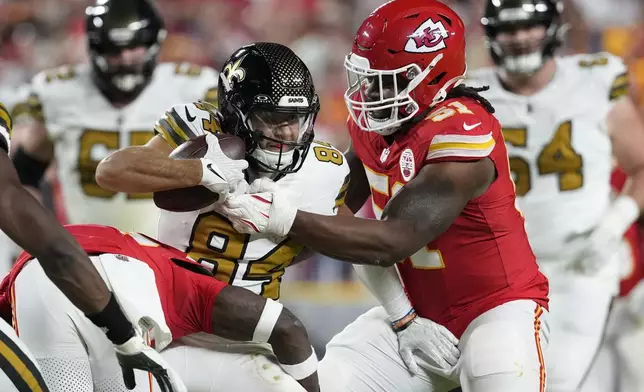 New Orleans Saints wide receiver Mason Tipton (84) is stopped by Kansas City Chiefs defensive end Mike Danna (51) during the second half of an NFL football game Monday, Oct. 7, 2024, in Kansas City, Mo. (AP Photo/Ed Zurga)