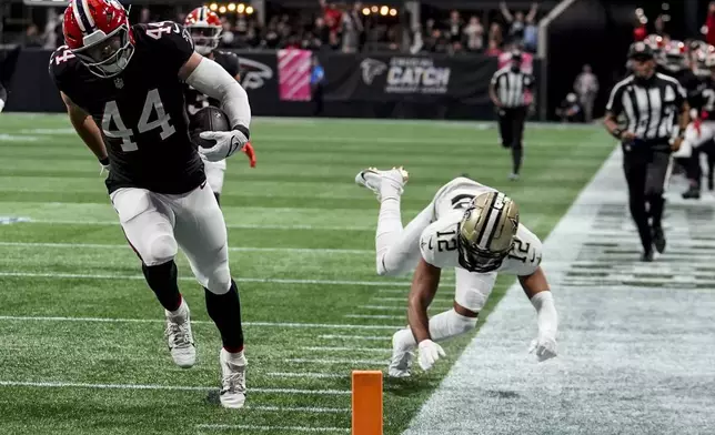 Atlanta Falcons linebacker Troy Andersen (44) runs into the end zone on an interception against the New Orleans Saints during the first half of an NFL football game, Sunday, Sept. 29, 2024, in Atlanta. (AP Photo/John Bazemore)