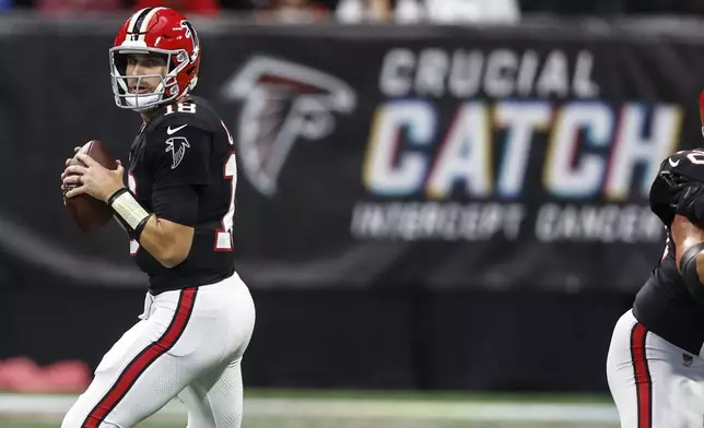 Atlanta Falcons quarterback Kirk Cousins (18) works in the pocket against the New Orleans Saints during the first half of an NFL football game, Sunday, Sept. 29, 2024, in Atlanta. (AP Photo/Butch Dill)