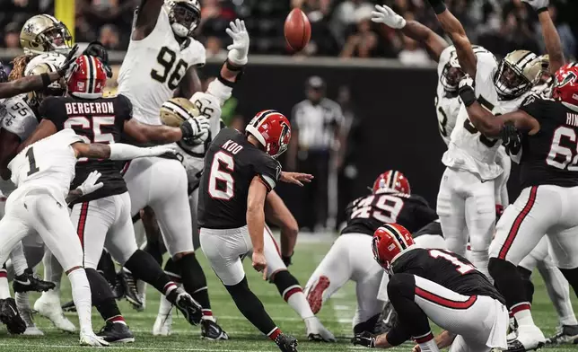 Atlanta Falcons place kicker Younghoe Koo, of South Korea, kicks a game winning 58-yard field goal against the New Orleans Saints during the second half of an NFL football game, Sunday, Sept. 29, 2024, in Atlanta. (AP Photo/John Bazemore)