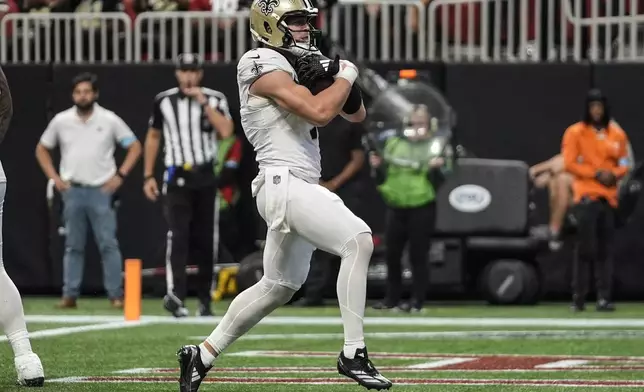 New Orleans Saints tight end Taysom Hill (7) runs into the end zone for a touchdown against the Atlanta Falcons during the first half of an NFL football game, Sunday, Sept. 29, 2024, in Atlanta. (AP Photo/John Bazemore)