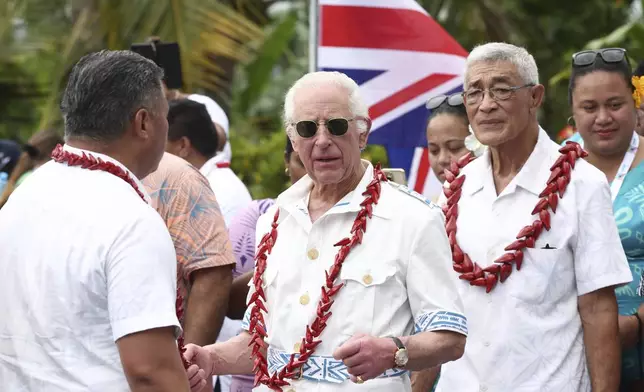 Britain's King Charles III, center, visits the Mangrove Restoration Project at Moata'a Village in Apia, Samoa Thursday, Oct. 24, 2024. (Manaui Faulalo/Pool Photo via AP)