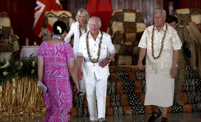 Britain's King Charles III, center, and Queen Camilla, second left, meet with Head of State of the Independent State of Samoa Tuimaleali'ifano Va'aleto'a Sualauvi II, right, during a welcome ceremony at the National University of Samoa in Apia, Thursday, Oct. 24, 2024. (Manaui Faulalo/Pool Photo via AP)