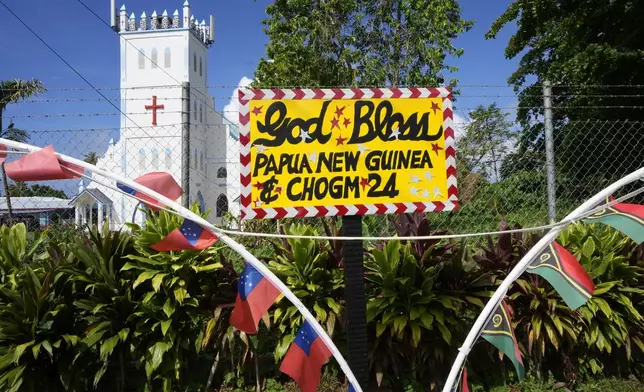 A handmade sign recognizes Papua New Guinea as the sponsored country of a village near in Apia, Samoa, on Sunday, Oct. 20, 2024, ahead of the Commonwealth Heads of Government meetings starting later in the week. (AP Photo/Rick Rycroft)