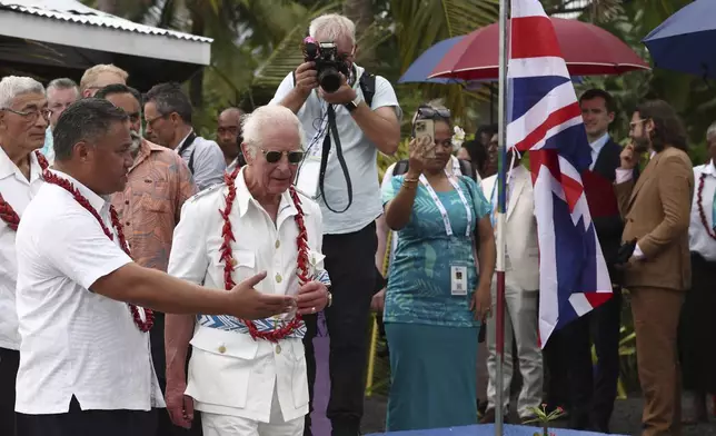 Britain's King Charles III, second left in front, visits the Mangrove Restoration Project at Moata'a Village in Apia, Samoa Thursday, Oct. 24, 2024. (Manaui Faulalo/Pool Photo via AP)