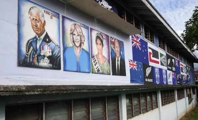 Painted portraits of King Charles III and Queen Camilla are displayed at a school in Apia, Samoa, on Sunday, Oct. 20, 2024, before a visit of the royals ahead of the Commonwealth Heads of Government meetings starting later in the week. (AP Photo/Rick Rycroft)