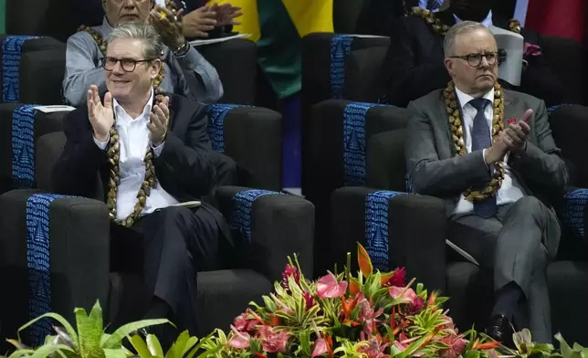 British Prime Minister Keir Starmer, left, and Australian Prime Minister Anthony Albanese react during the opening ceremony for the Commonwealth Heads of Government meeting in Apia, Samoa, Friday, Oct. 25, 2024. (AP Photo/Rick Rycroft/Pool)