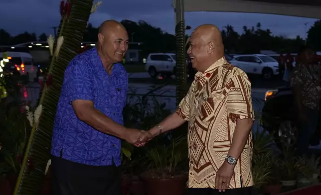 Samoan Deputy Prime Minister Tuala Iosefo Ponifasio, left, welcomes Prime Minister of Tuvalu Feleti Teo to the official welcome reception for the Commonwealth Heads of Government meeting in Apia, Samoa, Thursday, Oct. 24, 2024. (AP Photo/Rick Rycroft/Pool)