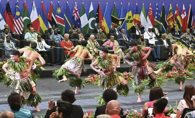 Britain's King Charles III, center, watches as dancers perform during the opening ceremony for the Commonwealth Heads of Government Meeting (CHOGM) in Apia, Samoa, on Friday, Oct. 25, 2024. (AP Photo/William West, Pool)