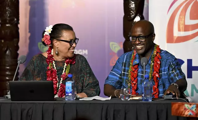 Commonwealth Secretary General Patricia Scotland, left, chats with Rwanda's Minister of Foreign Affairs Olivier Nduhungirehe during the final press conference at the Commonwealth Heads of Government Meeting (CHOGM) in Apia, Samoa, Saturday, Oct. 26, 2024. (William West/Pool Photo via AP)