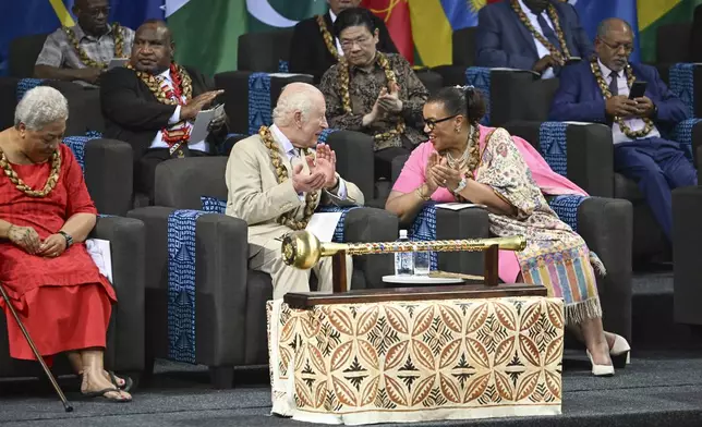 CHOGM Secretary General Patricia Scotland, right, talks to Britain's King Charles III, center, during the opening ceremony for the Commonwealth Heads of Government Meeting (CHOGM) in Apia, Samoa, on Friday, Oct. 25, 2024. (AP Photo/William West, Pool)