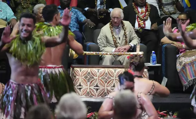 Britain's King Charles watches dancers perform during the opening ceremony for the Commonwealth Heads of Government meeting in Apia, Samoa, Friday, Oct. 25, 2024. (AP Photo/Rick Rycroft/Pool)