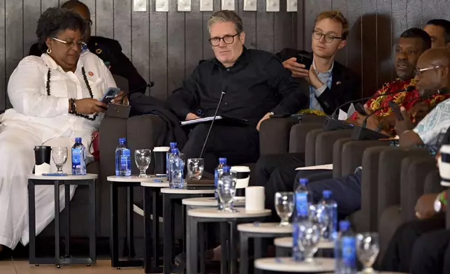 Britain's Prime Minister Keir Starmer, center, attends the Leaders' Retreat during the Commonwealth Heads of Government Meeting (CHOGM) in Apia, Samoa, Saturday, Oct. 26, 2024. (William West/Pool Photo via AP)