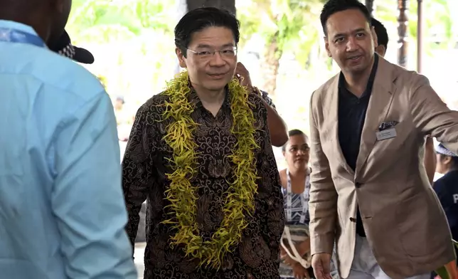 Singapore's Prime Minister Lawrence Wong arrives for the Leaders' Retreat during the Commonwealth Heads of Government Meeting (CHOGM) in Apia, Samoa, Saturday, Oct. 26, 2024. (William West/Pool Photo via AP)