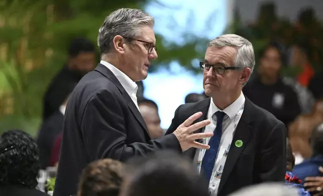 British Prime Minister Keir Starmer, left, attends a State Banquet during the Commonwealth Heads of Government Meeting (CHOGM) in Apia, Samoa, Thursday, Oct. 24, 2024. (William West/Pool Photo via AP)