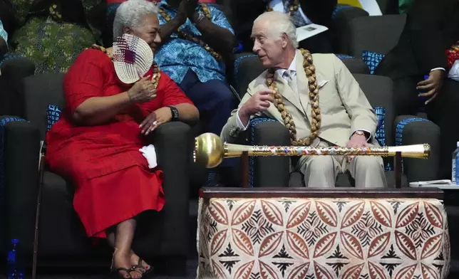 Britain's King Charles and Samoan Prime Minister Afioga Fiamē Naomi Mataʻafa, left, talk during the opening ceremony for the Commonwealth Heads of Government meeting in Apia, Samoa, Friday, Oct. 25, 2024. (AP Photo/Rick Rycroft/Pool)