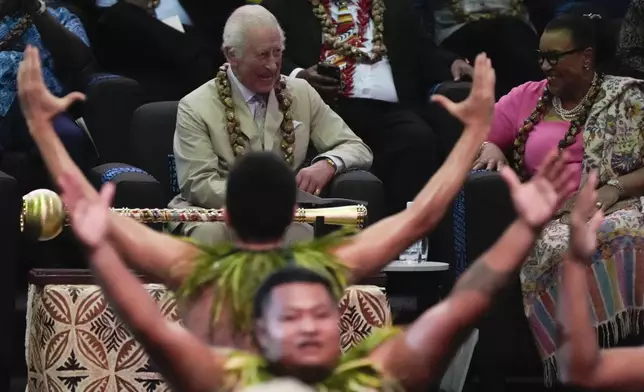 Britain's King Charles watches as dancers perform during the opening ceremony for the Commonwealth Heads of Government meeting in Apia, Samoa, Friday, Oct. 25, 2024. (AP Photo/Rick Rycroft/Pool)