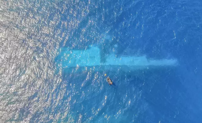 In this photo provided by the New Zealand Defence Force, divers survey the area around HMNZS Manawanui on the southern coast of Upulo, Samoa, after the Manawanui ran aground and sank on Oct. 6. (AC Jese Somerville/New Zealand Defence Force via AP)