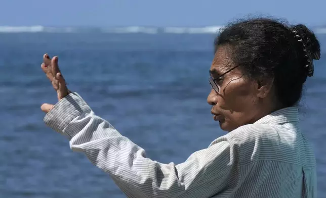 Netina Malae talks about how a New Zealand navy ship ran aground and sank on Oct. 6, near her Sima PJ Beach Fale resort in the village of Tafitoala, Samoa, Monday, Oct. 21, 2024. (AP Photo/Rick Rycroft)