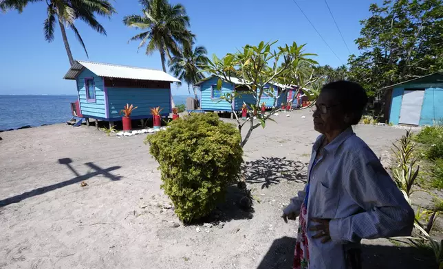 Netina Malae stands in the shade at her Sima PJ Beach Fale resort in the village of Tafitoala, Samoa, on Monday, Oct. 21, 2024, near where a New Zealand navy ship ran aground and sank on Oct. 6. (AP Photo/Rick Rycroft)