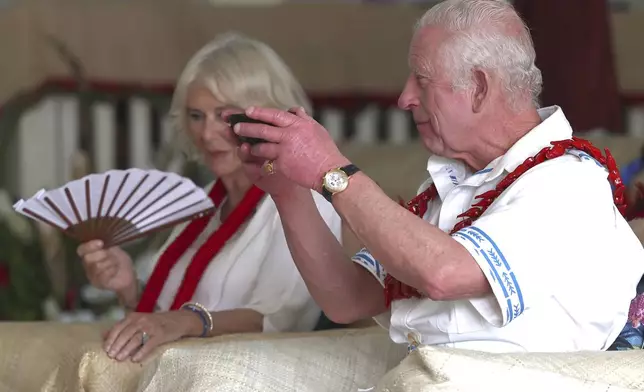 King Charles III drinks kava, locally known as "ava," as Queen Camilla looks on during an ava ceremony to welcome royals at Moata village in Samoa's capital Apia, Thursday, Oct. 24, 2024. (Manaui Faulalo/Pool Photo via AP)