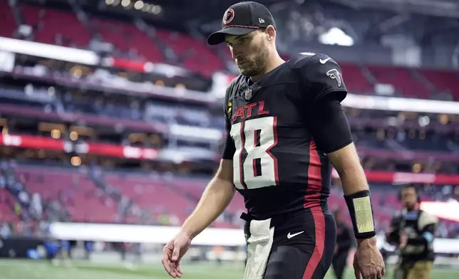 Atlanta Falcons quarterback Kirk Cousins walks off the field following the Falcons' loss to Seattle Seahawks in an NFL football game, Sunday, Oct. 20, 2024, in Atlanta. (AP Photo/ Mike Stewart )