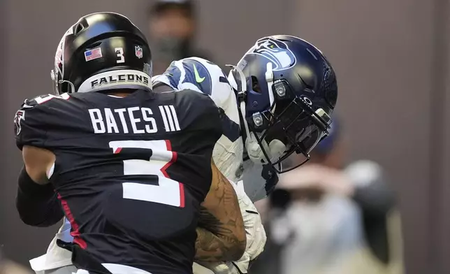 Seattle Seahawks wide receiver DK Metcalf (14) makes a catch for a touchdown as Atlanta Falcons safety Jessie Bates III (3) defends during the first half of an NFL football game, Sunday, Oct. 20, 2024, in Atlanta. (AP Photo/ Mike Stewart )