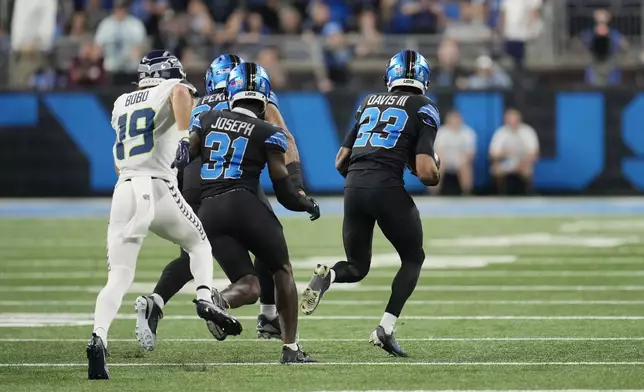 Detroit Lions cornerback Carlton Davis III (23) recovers a fumble from Seattle Seahawks wide receiver DK Metcalf and runs downfield during the first half of an NFL football game, Monday, Sept. 30, 2024, in Detroit. (AP Photo/Paul Sancya)